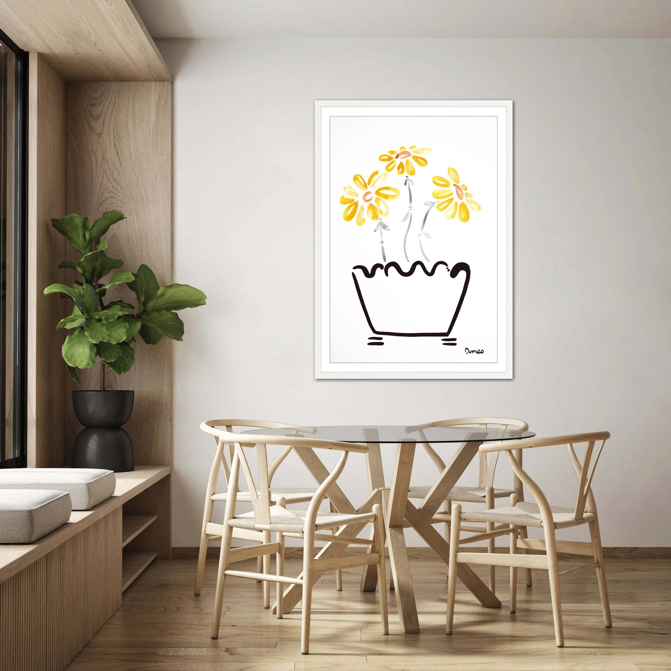 A framed yellow floral painting by Molly Dimeo hangs above a dining table.
