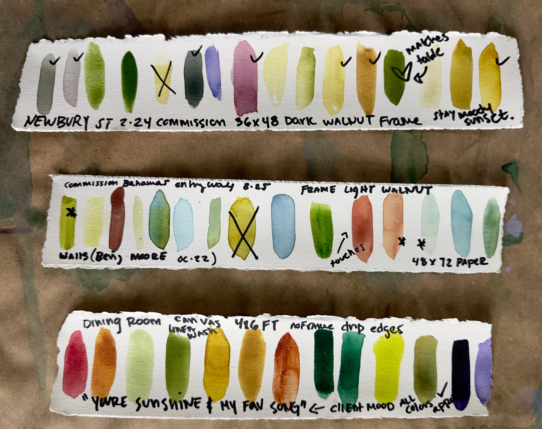 Three strips of watercolor paint swatches on deckled paper.